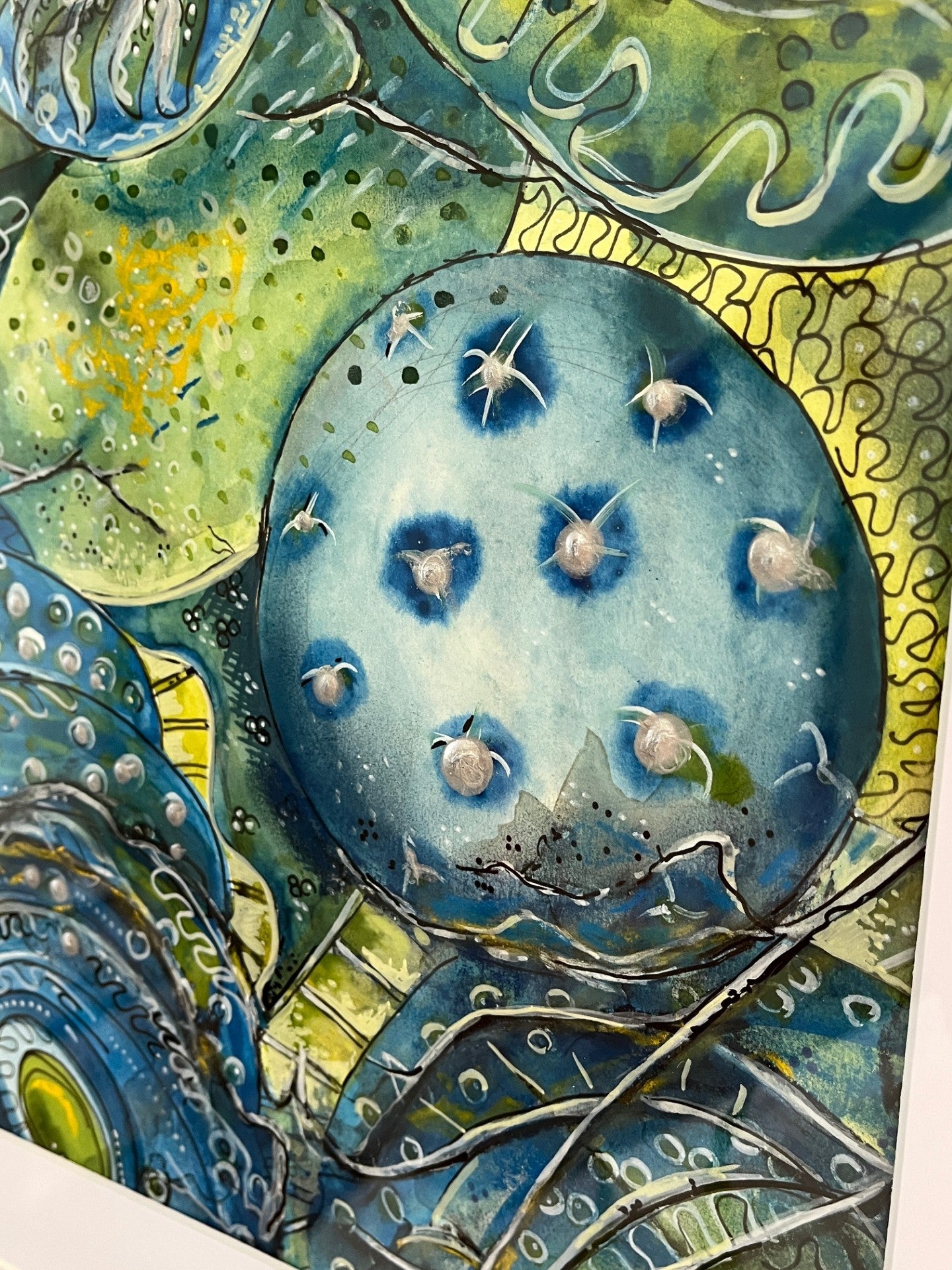 Artistic depiction of marine life with blue sea creatures on a green and blue background