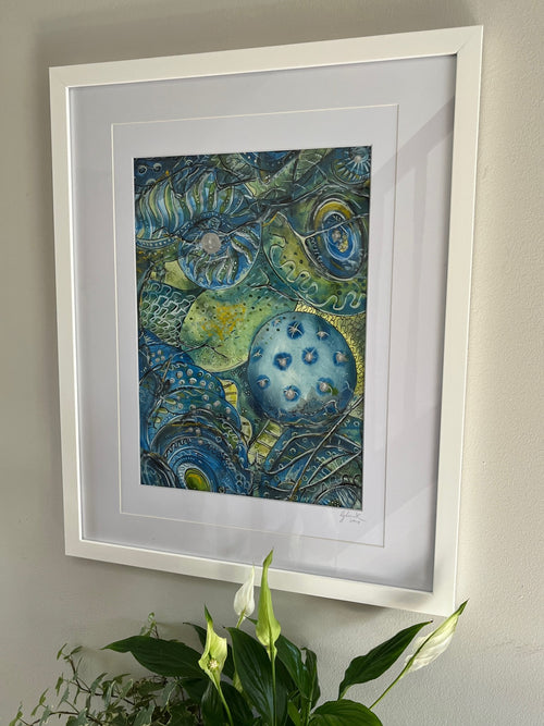 Framed artwork with blue and green abstract design on a wall