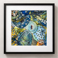 Framed abstract artwork with colorful fish and pearls on a white background